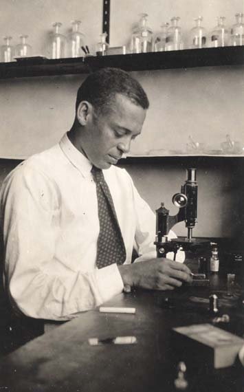Ernest Everett Just at work with a microscope
